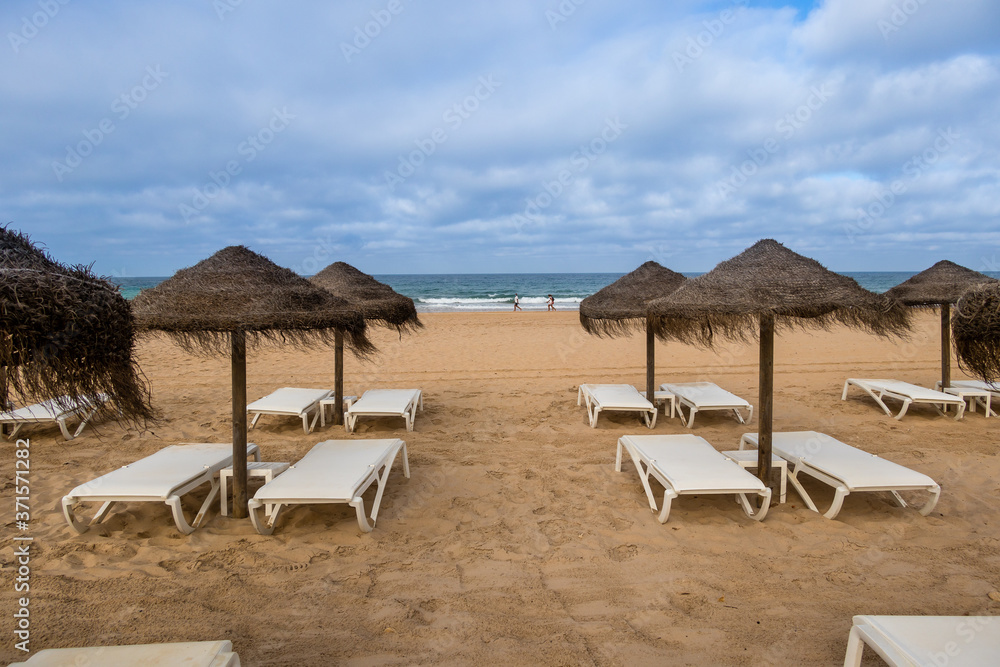 Parasols and hammocks on La Barrosa beach in Sancti Petri, Cadiz, Spain