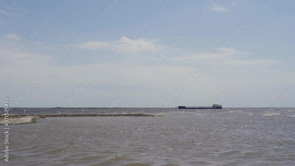 Large tankers and tugs go along the huge river. The ship is sailing along the Volga. Large tankers and tugs go along the huge river. The ship is sailing along the Volga.