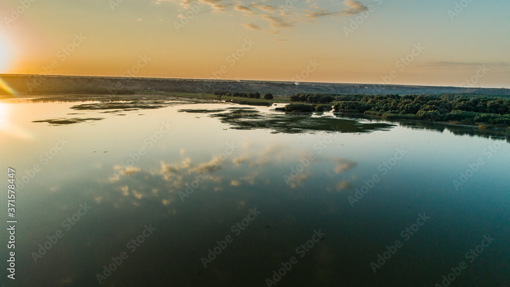 aerial shot of morning clouds reflected in lake beleu, moldova