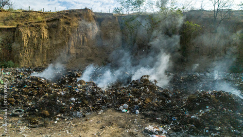 burning dump with white smoke shot from drone
