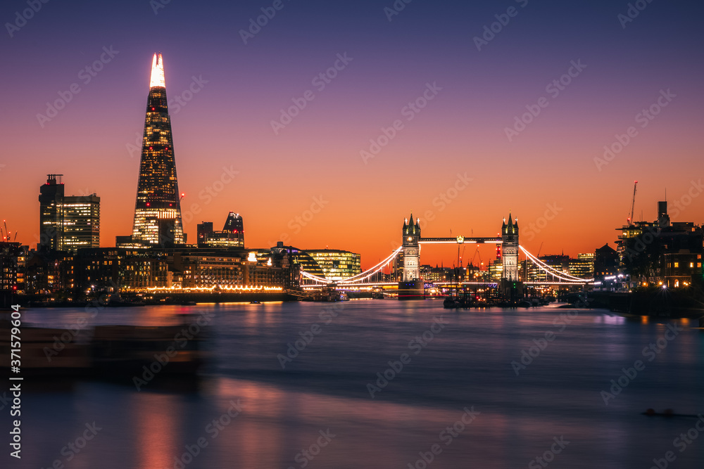 Illuminated London city skyline with Tower bridge