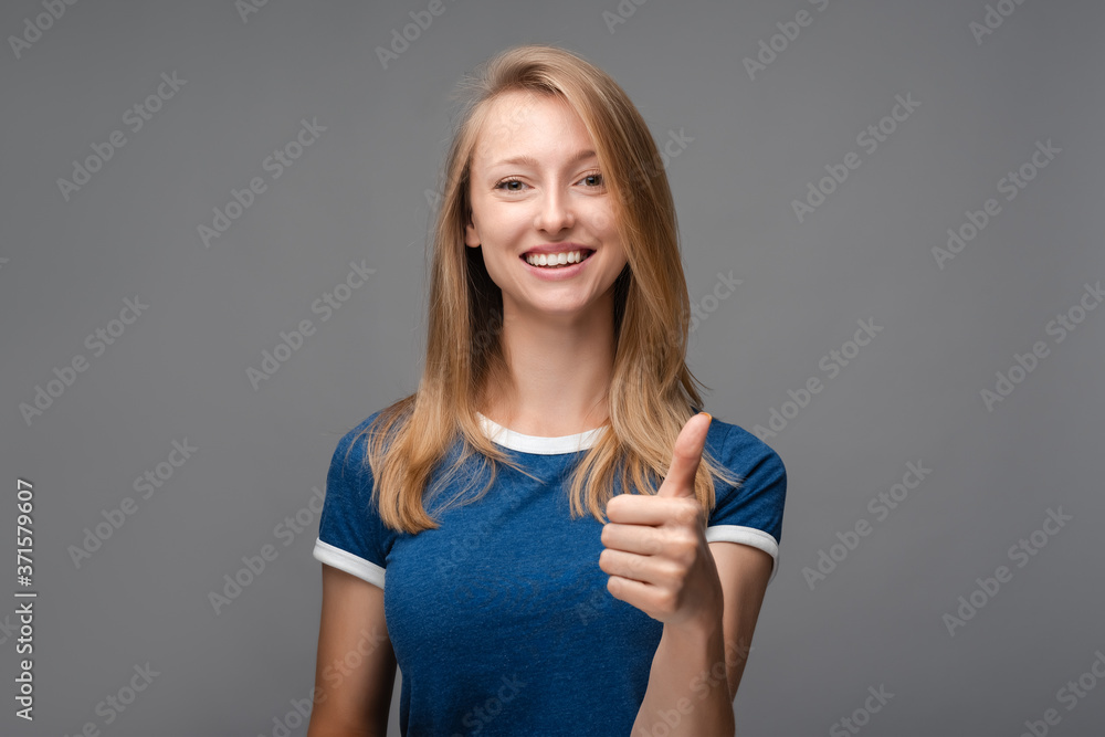 Cheerful girl looking at the camera with happy expression, showing OK gesture Cheerful girl looking at the camera with happy expression, showing OK gesture