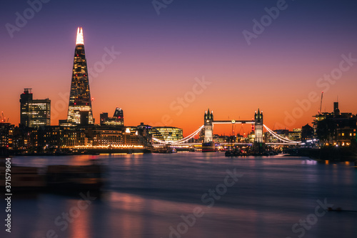 Illuminated London city skyline with Tower bridge photo