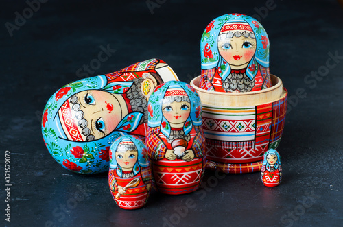 Five red matryoshka. Traditional Russian toy. Black concrete background photo