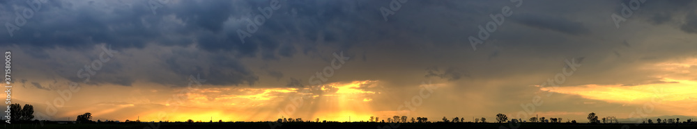cloudy sunset over field landscape panorama