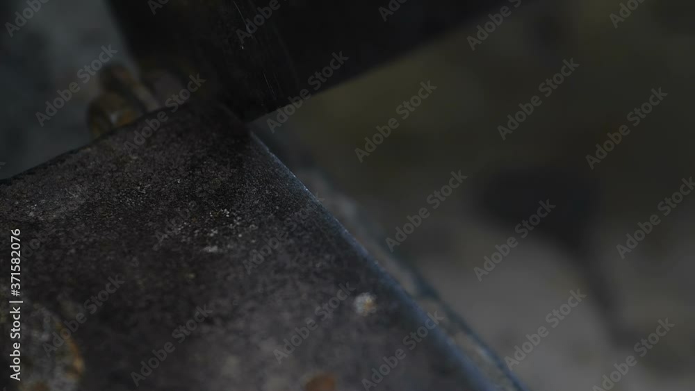 Close-up shot of a metal guillotine cutting cardboard in a small furniture factory. Master working in orange protective gloves. Slow motion 200 fps Close-up shot of a metal guillotine cutting cardboard in a small furniture factory. Master working in orange protective gloves. Slow motion 200 fps