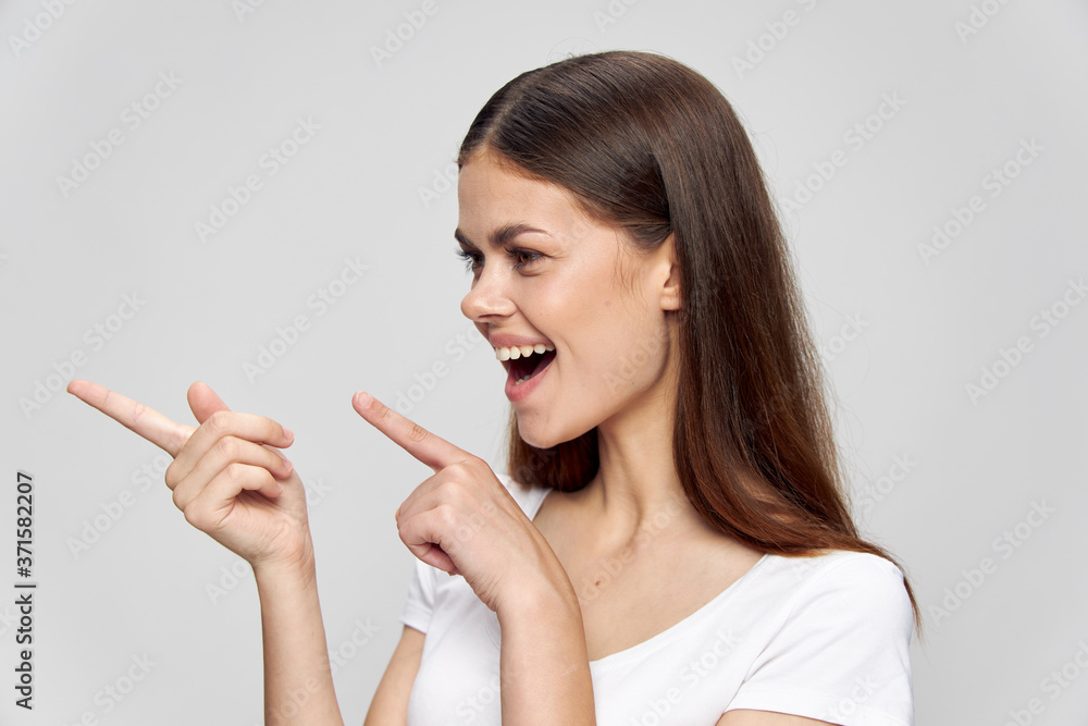 woman shows fingers to the side and laughs background Copy Space woman shows fingers to the side and laughs background Copy Space