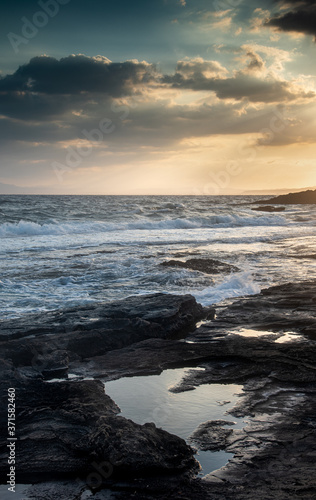 Rocky seashore with windy waves at sunset. Xilofagou Larnaca Cyprus