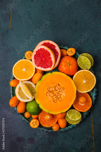 Flat lay layout of fruit citrus and other sommer fruits on green background © Brebca