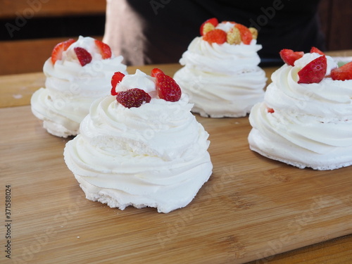 the chef decorates the dessert with fresh raspberries and strawberries. Anna Pavlovna's dessert photo