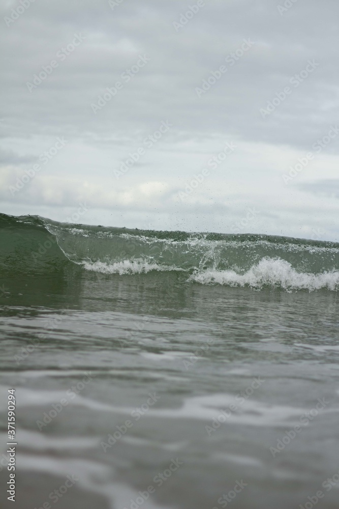 Small waves breaking off the West coast, New Zealand. Small waves breaking off the West coast, New Zealand.