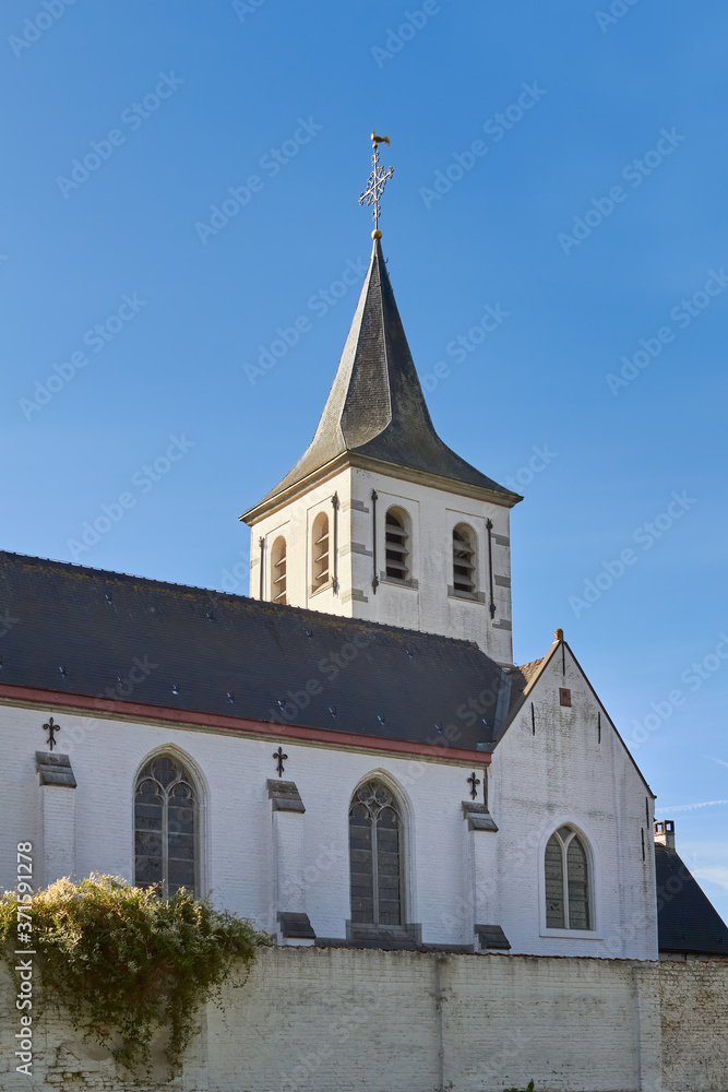 Tower of white country village church in Flanders Belgium Sint-Martens-Latem