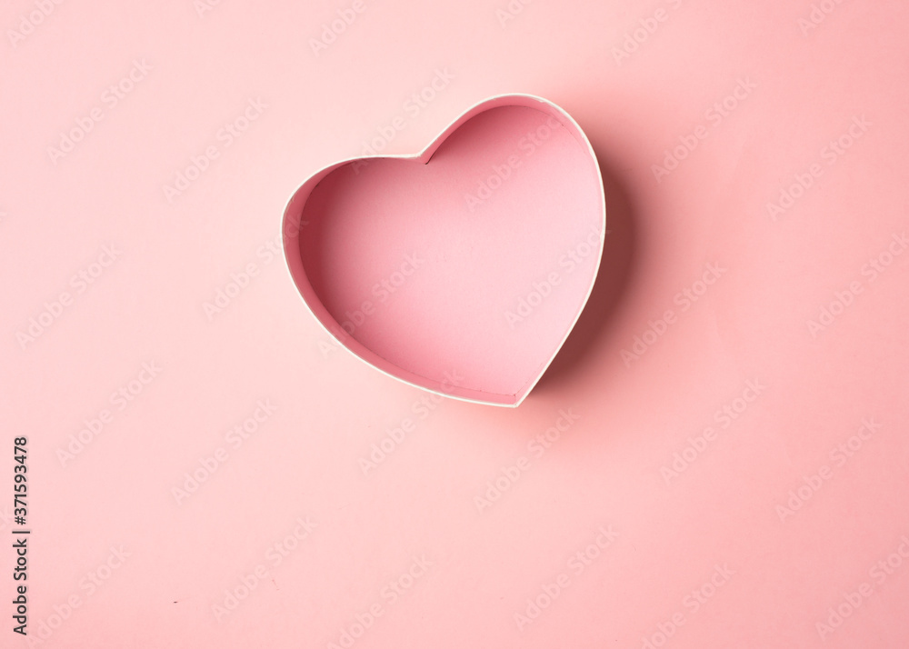 A gift box in the form of a heart on a pink background. Gift favorite for Valentine 's Day
