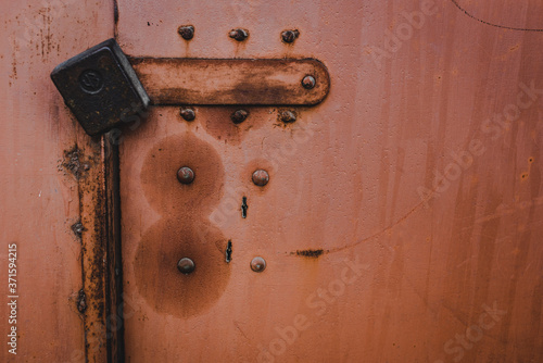 The old iron background is painted yellow, orange, purple, red in with rust and chips