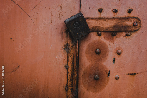 The old iron background is painted yellow, orange, purple, red in with rust and chips