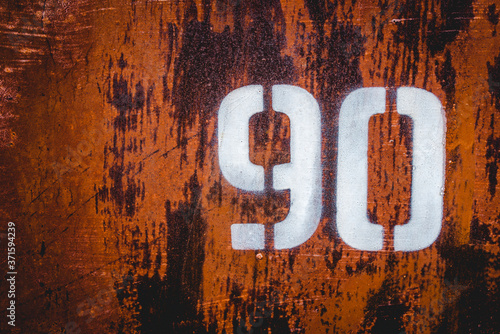 The old iron background is painted yellow, orange, purple, red in with rust and chips