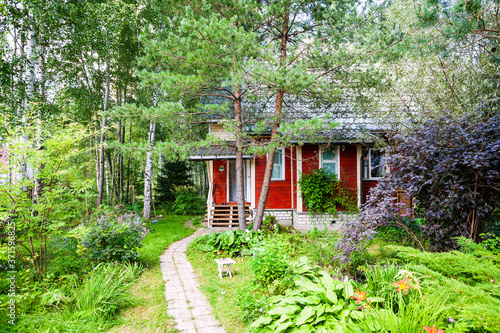 wooden summerhouse in ornamental garden in Russia in summer photo