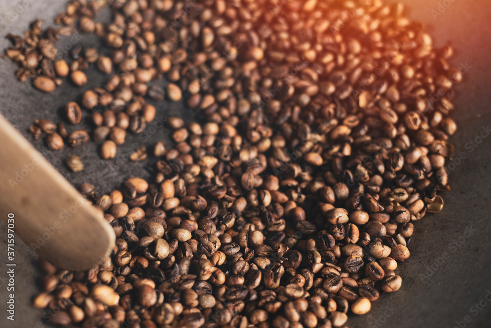 Coffee beans roasted traditional,coffee beans are being roasted in a pan.Roasting the peeled coffee beans. Coffee beans roasted traditional,coffee beans are being roasted in a pan.Roasting the peeled coffee beans.