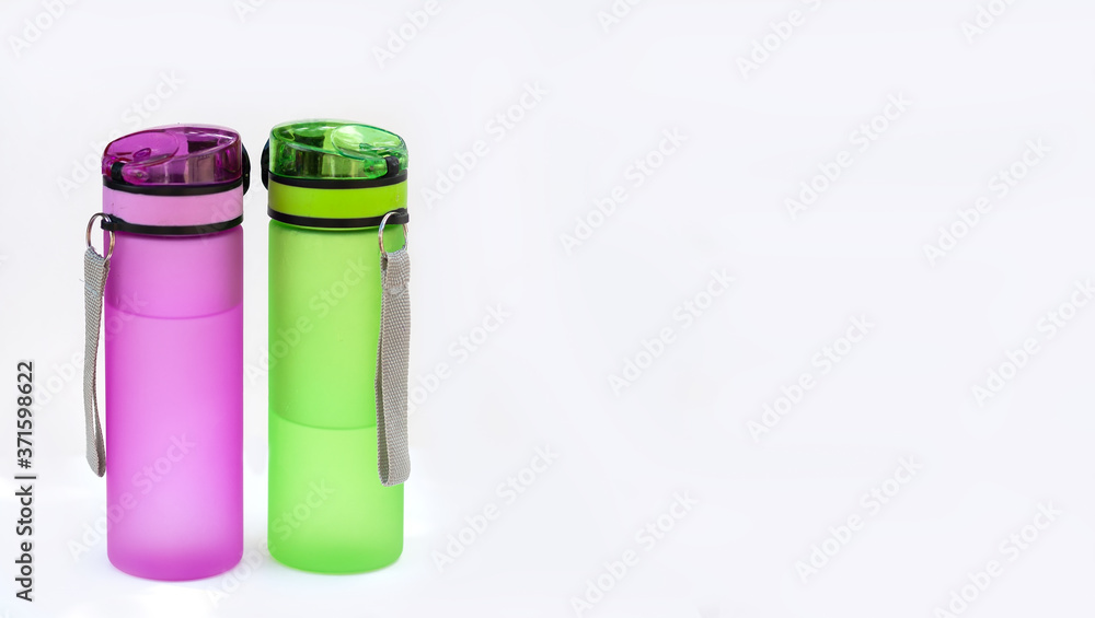 Two sports bottles (drinkers) with water isolated on a white background. The concept of drinking pure water Two sports bottles (drinkers) with water isolated on a white background. The concept of drinking pure water