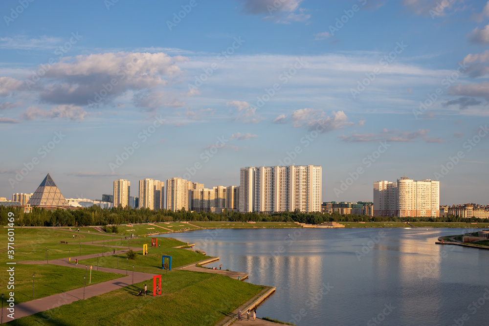 View of the river embankment Esil and Presidential Park. Sunset time.