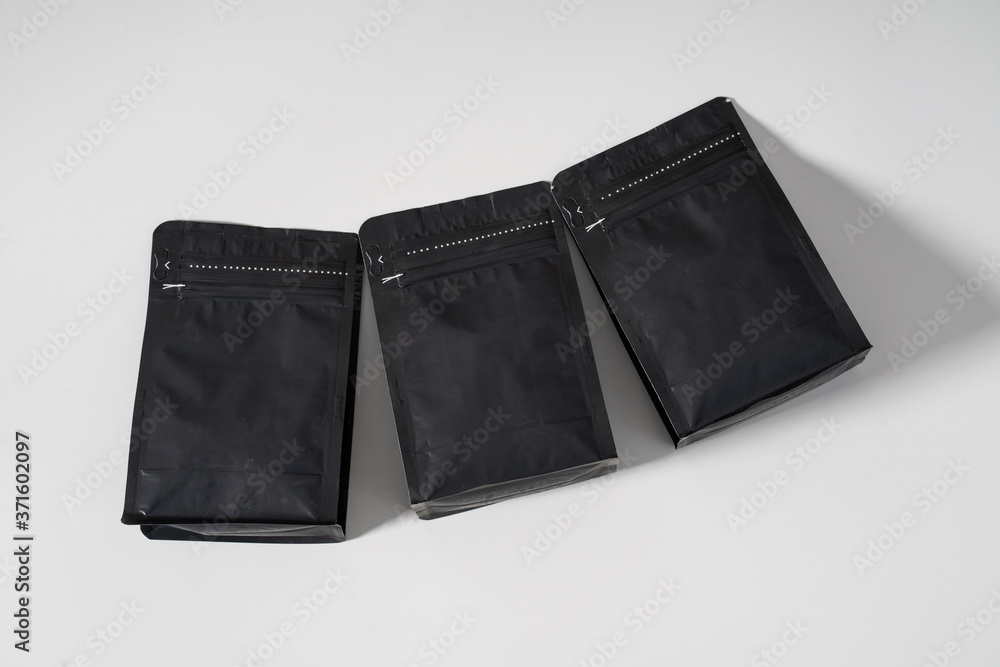 blank black standing pouch container lay over white background. product mockup blank black standing pouch container lay over white background. product mockup