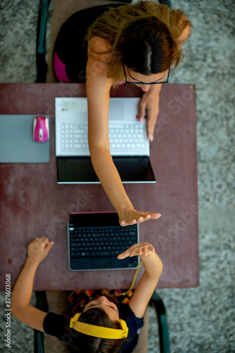 Mother and daughter enjoying wireless technology
