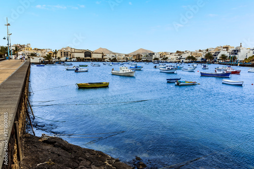 A view from the promenade of boats moored in the lagoon of Charco de San Gines in Arrecife, Lanzarote on a sunny afternoon