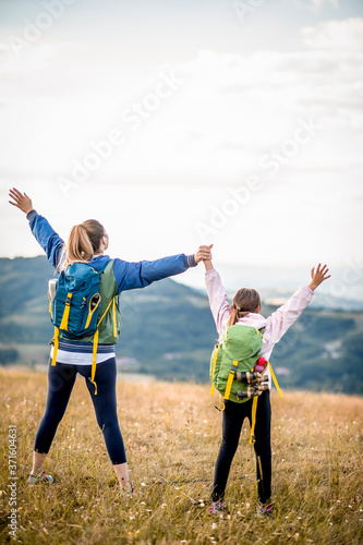 Young single mother hiking together with her daughter