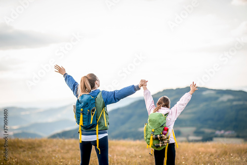 Young single mother hiking together with her daughter