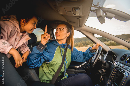 Family driving in car, mother shouting at daughter