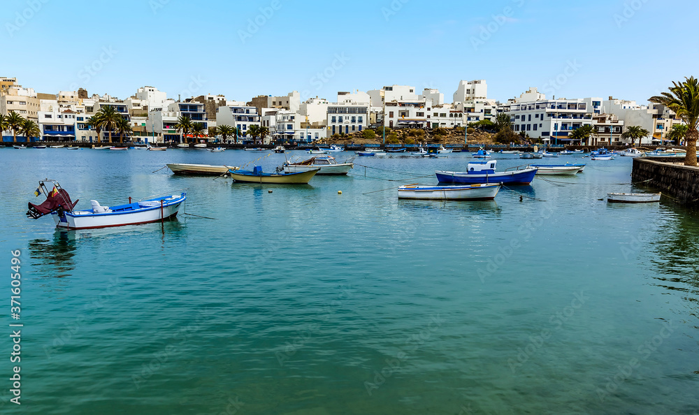 The lagoon of Charco de San Gines in Arrecife, Lanzarote and a flotilla of small boats on a sunny afternoon