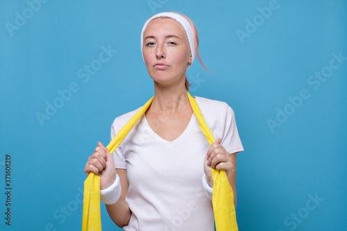 Young caucasian woman is tired after exercing at gym photo