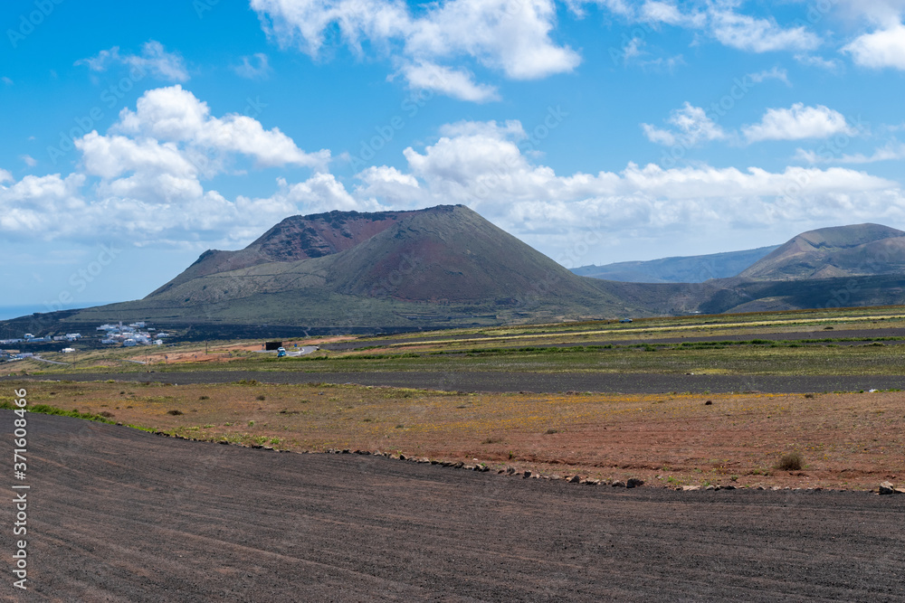Volcano crater and lava field with vegetation in Lanzarote Canary Islands.