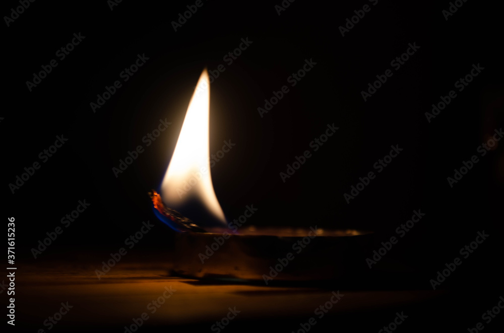 burning candle on a dark background burning candle on a dark background