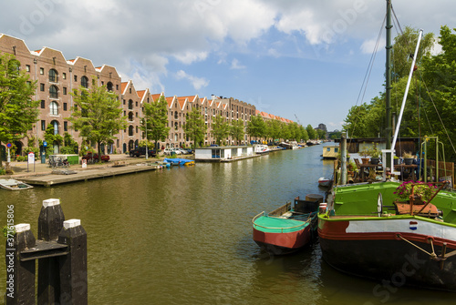 houseboat in a new neighborhood caught on the sea in Amsterdam © hectorchristiaen