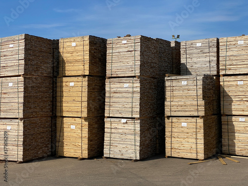 Stacked wooden pallets at wood sawmill and machinery