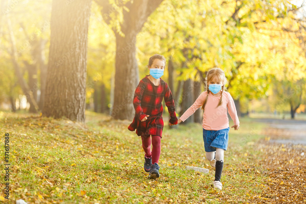 Little european girls wearing mask for protect pm2.5 and Covid-19. Sick child. Little girls look at the camera posing in a red dress with a medical mask on her face. Copy space. Little european girls wearing mask for protect pm2.5 and Covid-19. Sick child. Little girls look at the camera posing in a red dress with a medical mask on her face. Copy space.