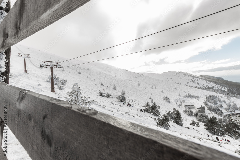 Fototapeta premium Panoramic view of snow mountains with a ski lift