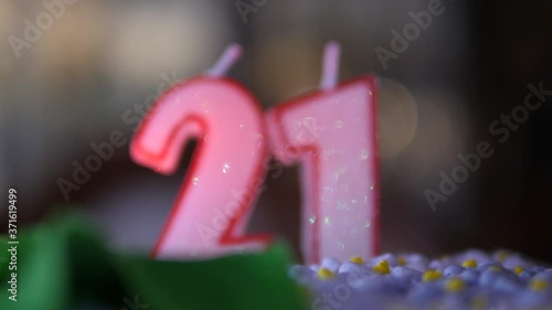 Glitter white Candles 21 Birthday cake. Numbers twenty one. Bokeh shape out of focus bg. Dolly move isolated close up.