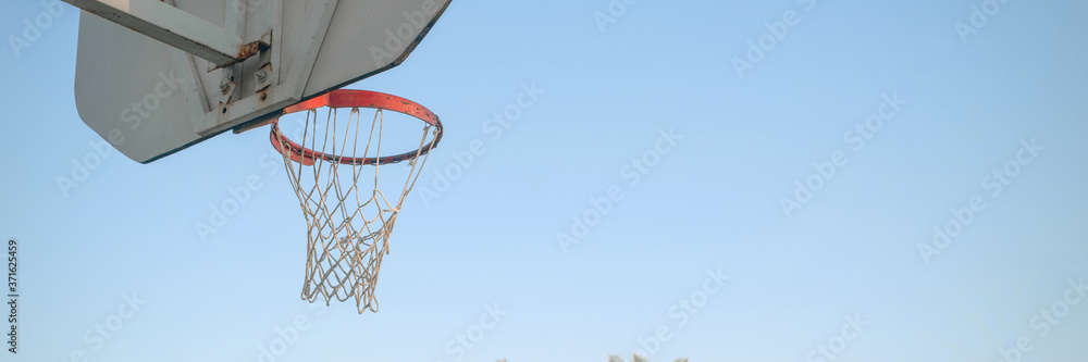 basketball backboard with metal hoop blue sky background with copy space outdoor