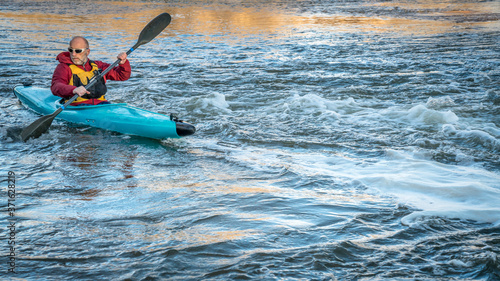 senior male paddling a whitewater kayak on a turbulent river - South Platte River in northern Colorado © MarekPhotoDesign.com