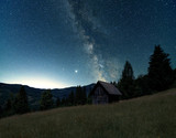 Night landscape with miklky way, Long exposure night sky shot. Alone cabin at night in mountains 