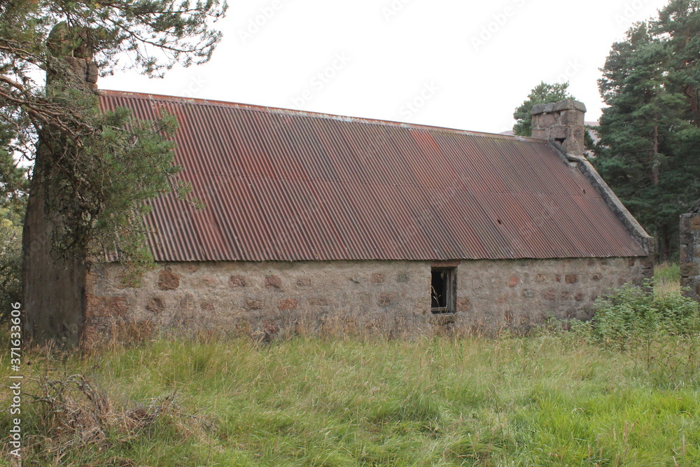 Stone built farm house with tin roof and copy space Stone built farm house with tin roof and copy space