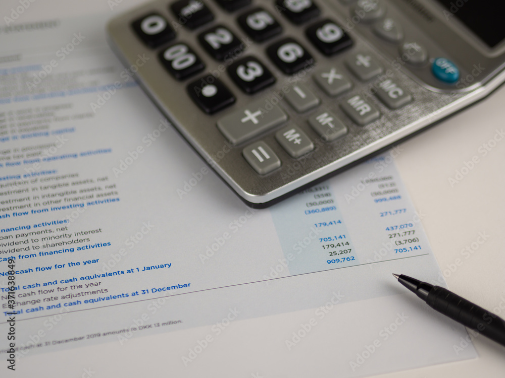Financial statement concept:Cash flow statement paper sheet with calculator and pen. Financial statement concept:Cash flow statement paper sheet with calculator and pen.
