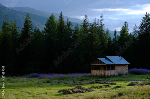 Wooden house surrounded by mountains. Altai, Siberia