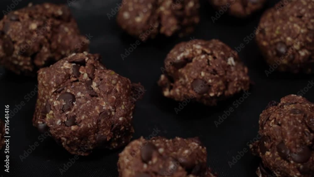 Tilt Up of Raw chocolate chip oatmeal cookie dough balls, Closeup Tilt Up of Raw chocolate chip oatmeal cookie dough balls, Closeup