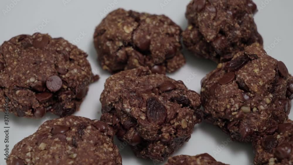 Tilt Up of Oatmeal raisin cookies on white background, closeup detail Tilt Up of Oatmeal raisin cookies on white background, closeup detail