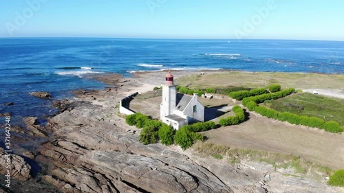 cinematic aerial drone shot of The Pointe des Chats lighthouse, danger indicator located on the point of the same name in the south-east of the island of Groix.