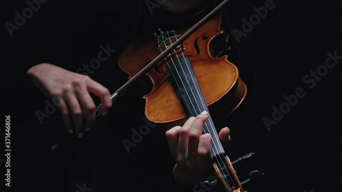 Girl violin musician playing at studio. Studio black background