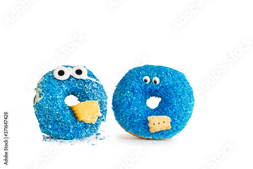 Two Blue donut with eyes and biscuit against white Background
